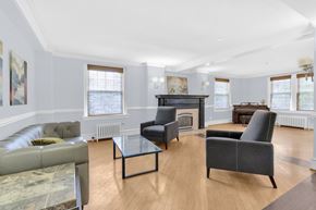 Buffalo apartment for rent - A living room with a fireplace and a grey couch.