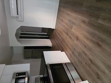 Buffalo apartment for rent - A modern kitchen with a stainless steel oven and a wooden floor.