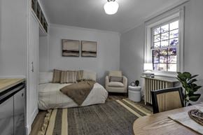Buffalo apartment for rent - A cozy bedroom with a bed, chair, and window.