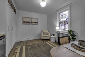 Buffalo apartment for rent - A dining room with a table set for two and a window with stained glass.
