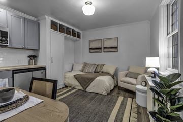 Buffalo apartment for rent - A well-lit, modern kitchen and living room with a dining table and chairs.