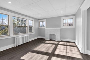 Buffalo apartment for rent - A room with a fireplace and a large window.