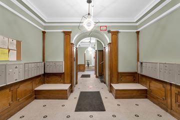 Buffalo apartment for rent - A long hallway with a black and white checkered floor.
