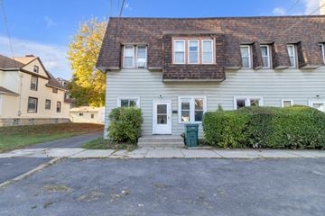 Buffalo apartment for rent - A grey house with a white door and windows.