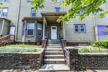Buffalo apartment for rent - A house with a front porch and stairs leading up to it.