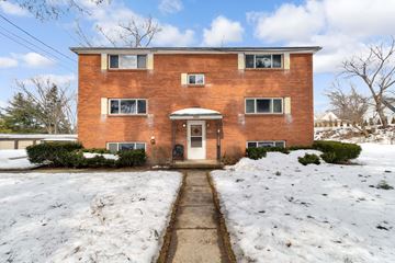 North Boston apartment for rent - A red brick house with a white door and windows.