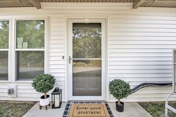 Buffalo apartment for rent - A white house with a glass door and a sign on the mat that says "Home Sweet Apartment".