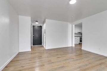 Buffalo apartment for rent - A room with wooden floors and white walls.