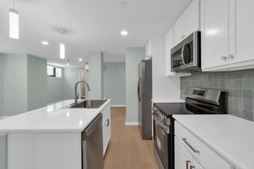 Buffalo apartment for rent - A kitchen with white cabinets and a black oven.