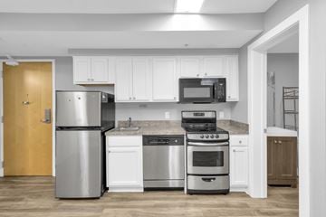 Buffalo apartment for rent - A kitchen with white cabinets and stainless steel appliances.