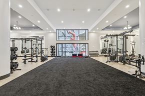 Pittsburgh apartment for rent - A spacious gym with a variety of equipment and a large mirror on the wall. at LiveWell Apartments, Pennsylvania