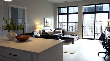 A modern living room with a large window and a view of the city.