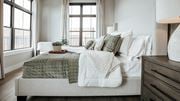 Fort Wayne apartment for rent - A bedroom with a bed covered in a green and white comforter. at The Pearl, Fort Wayne, IN