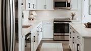 Fort Wayne apartment for rent - A modern kitchen with white cabinets and stainless steel appliances. at The Pearl, Fort Wayne, IN