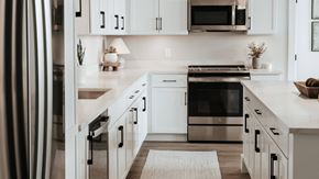 Fort Wayne apartment for rent - A modern kitchen with white cabinets and stainless steel appliances. at The Pearl, Fort Wayne, IN
