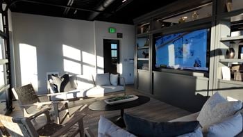 Community lounge with a flat screen tv and comfortable seating.