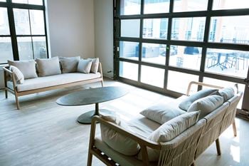 A living room with a couch, chair, and table.