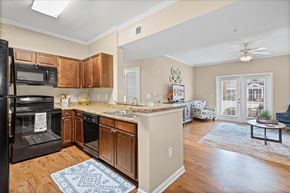 Mobile apartment for rent - A kitchen with a black stove top oven and wooden cabinets.