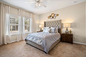 Mobile apartment for rent - A bedroom with a large bed and a ceiling fan.