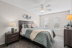 Mobile apartment for rent - A bedroom with a bed, nightstand, and a ceiling fan.