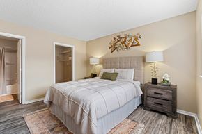 Mobile apartment for rent - A bedroom with a large bed and a wooden dresser.