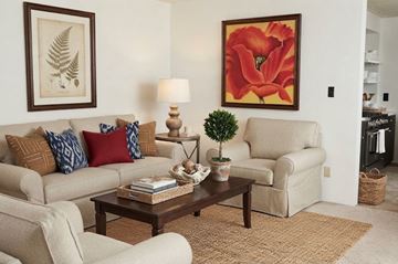 Tuscaloosa townhouse for rent - A living room with a couch, chair, and a table with a plant on it.