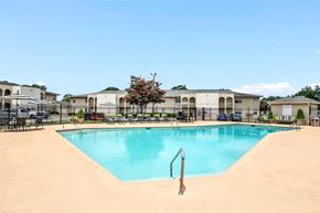 Tuscaloosa apartment for rent - A swimming pool in a residential area with a sandy bottom.