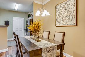 Huntsville apartment for rent - a dining room table with a vase of flowers on it