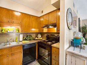 Birmingham apartment for rent - a kitchen with black appliances and wooden cabinets