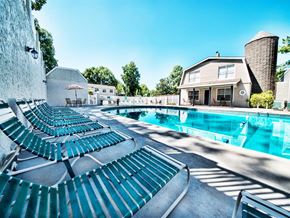 Huntsville apartment for rent - a swimming pool with lounge chairs next to a house