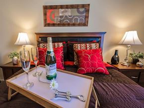 Mobile apartment for rent - a bedroom with a bed and a bottle of wine on a table