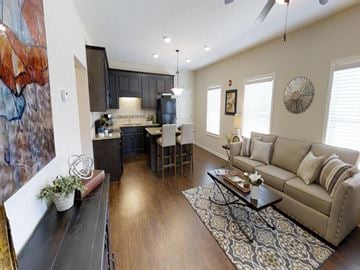 Tuscaloosa apartment for rent - a living room and kitchen with a couch and a table