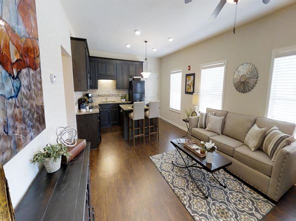 Tuscaloosa apartment for rent - a living room and kitchen with a couch and a table