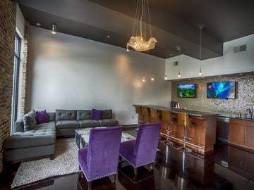 Tuscaloosa apartment for rent - a living room with purple chairs and a bar