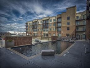 Tuscaloosa apartment for rent - a swimming pool with a building in the background