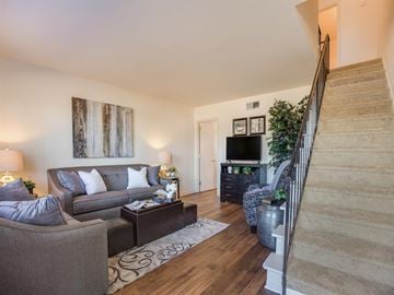 Tuscaloosa townhouse for rent - a living room with two couches and a staircase