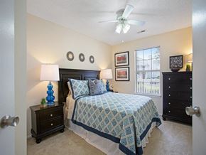 Tuscaloosa apartment for rent - a bedroom with a bed and a ceiling fan