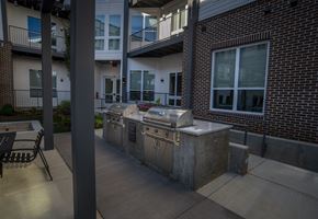 Madison apartment for rent - A BBQ grill is on a patio in front of a brick building.