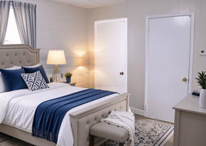 Tuscaloosa townhouse for rent - A bedroom with a bed, a nightstand, and a window with curtains.