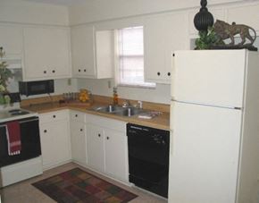 Tuscaloosa townhouse for rent - A kitchen with white cabinets and a black oven.