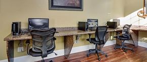 Tuscaloosa apartment for rent - a home office with three computers on a long desk