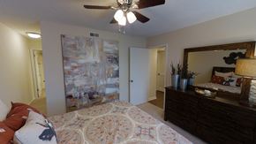 Northport apartment for rent - a bedroom with a bed and a ceiling fan