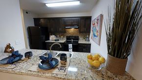 Northport apartment for rent - a kitchen with black appliances and granite counter tops