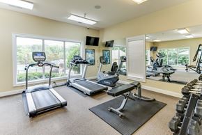 Huntsville apartment for rent - A gym with treadmills, elliptical machines, and dumbbells.
