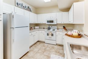 Huntsville townhouse for rent - a white kitchen with white appliances and white cabinets