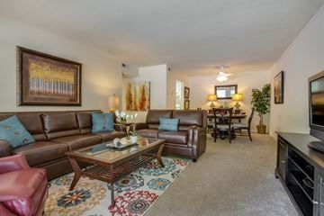 Tuscaloosa apartment for rent - A living room with brown leather couches and a glass coffee table.