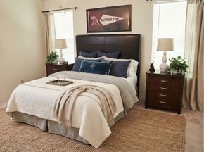 Tuscaloosa townhouse for rent - A bedroom with a large bed and a painting on the wall.