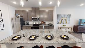 Madison apartment for rent - A modern kitchen with a dining table set for four.