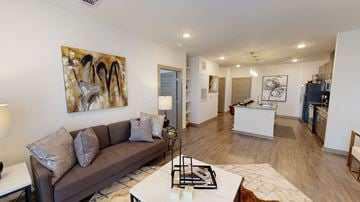 Madison apartment for rent - A living room with a brown couch and a painting on the wall.