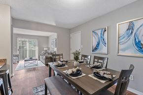 Pelham apartment for rent - A dining room with a wooden table set for a meal.